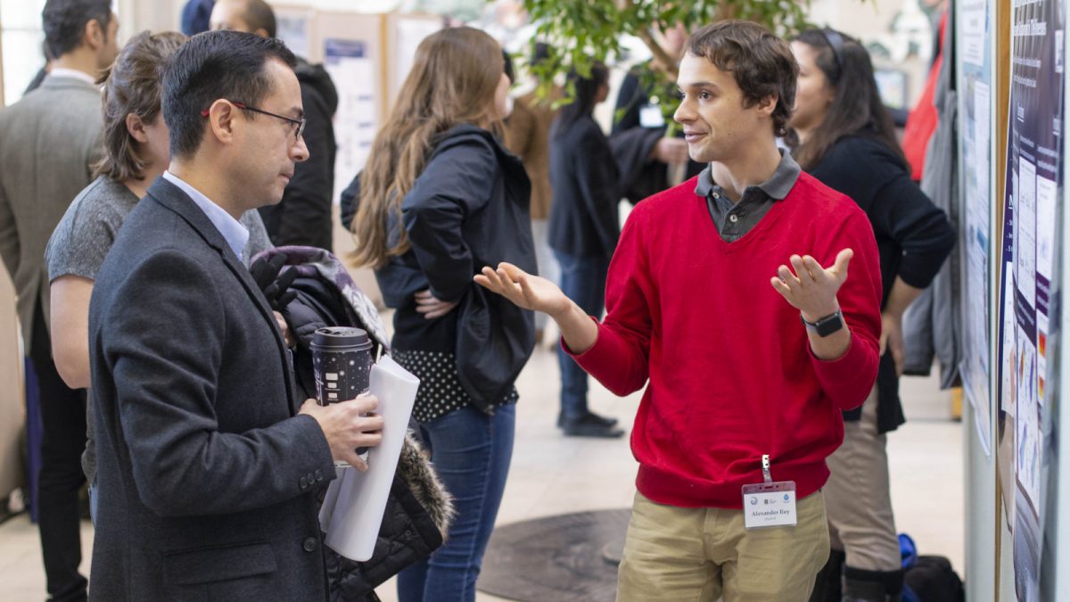 Ph.D. Student Alexander Rey presenting his poster to Dr. Carlos Escobedo.